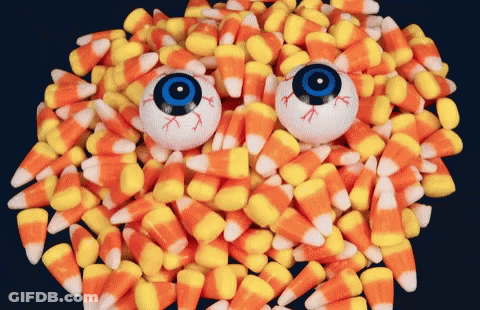 Pile Of Candy Corn With Two Eyeballs GIF