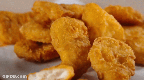 Pile Of Chicken Nuggets With Bite GIF