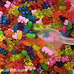 Pile Of Gummy Bears With Toothbrush GIF