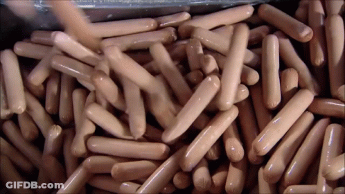Pile Of Hot Dogs Poured Into Container GIF
