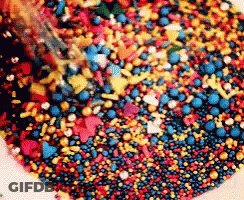 Pile Of Red Yellow And Blue Sprinkles GIF
