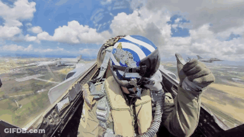Pilot In Blue And White Helmet With Greek Flag Thumbs Up GIF