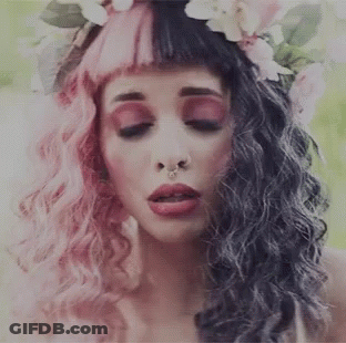 Pink-And-Black-Haired Woman With Flower Crown And Nose Ring GIF