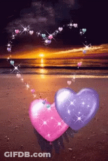 Pink And Purple Hearts On A Beach With Hearts Coming Out Of Them GIF