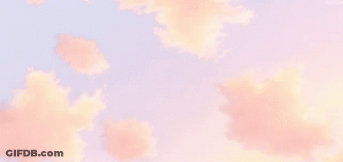 Pink Clouds In A Blue Sky With A Few Trees In The Background GIF