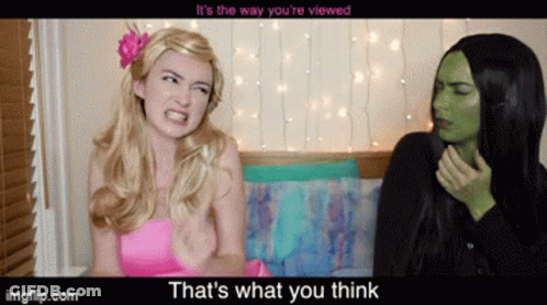 Pink Dress Woman Talking To Green Woman GIF