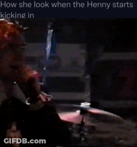Pink-Haired Man At Microphone In Dark Room GIF