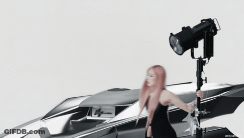 Pink Haired Woman In Front Of Silver Lyman Car GIF