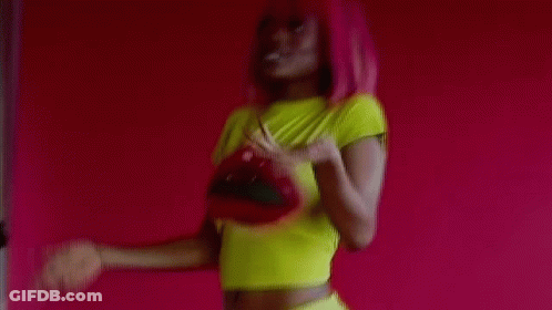 Pink-Haired Woman In Yellow Crop Top Holding Red Purse GIF