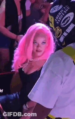 Pink-Haired Woman Next To Man In Black Shirt GIF