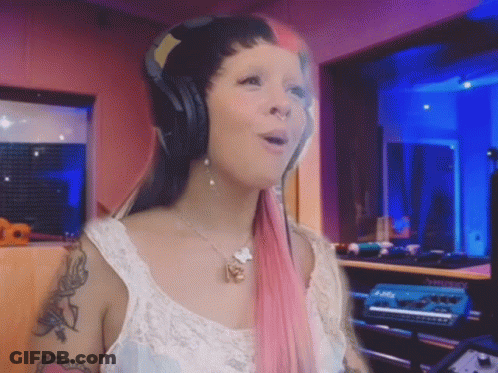 Pink-Haired Woman Singing Into Microphone With Headphones GIF