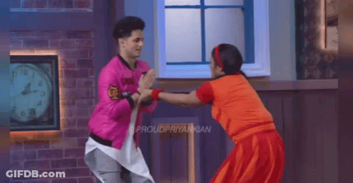 Pink Jacket Man And Red Dress Woman Dancing By Clock GIF