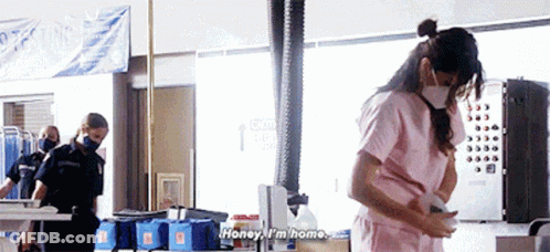 Pink Scrub Top Woman Talking To Masked Man GIF