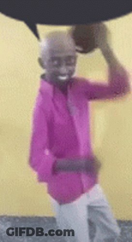 Pink Shirt Man Holding Basketball Over Head Smiling GIF