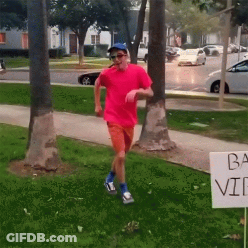 Pink Shirt Man Running By Ba Vi Sign GIF