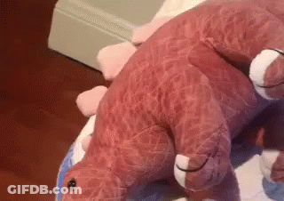 Pink Stuffed Dinosaur Laying On White Plate GIF