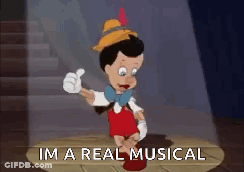 Pinocchio Is Giving A Thumbs Up And Saying `` I 'M A Real Musical '' While Standing On A Stage . GIF