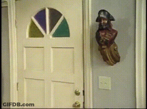 Pirate Statue Near Stained Glass Door GIF