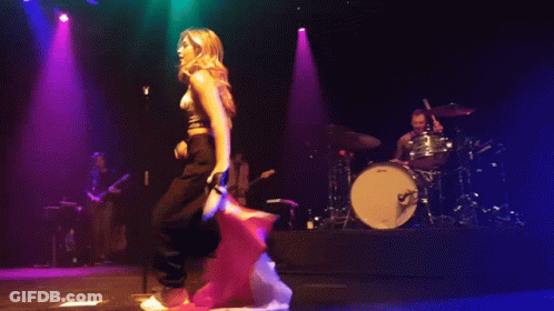 Pixelated Woman On Stage With Drum Set GIF