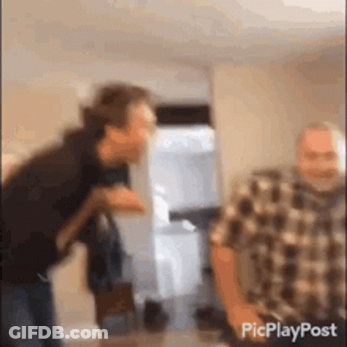 Plaid Shirt Man Standing Next To Another Man GIF