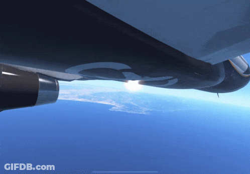 Plane Flying In Sunlit Sky GIF