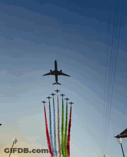 Plane Flying Over Row Of Planes With Smoke Trails GIF