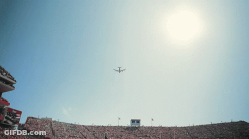 Plane Flying Over Stadium With Scoreboard GIF