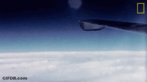 Plane Flying Through Clouds With National Geographic Logo GIF