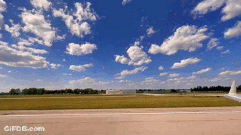 Plane On Runway Blue Sky White Clouds GIF