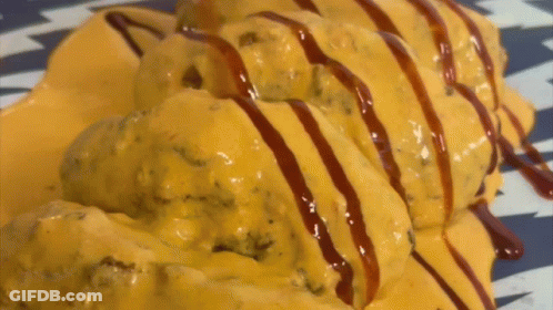 Plate Of Food Covered In Cheese And Sauce GIF