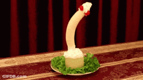 Plate Of Food That Looks Like A Penis With Red Curtain GIF