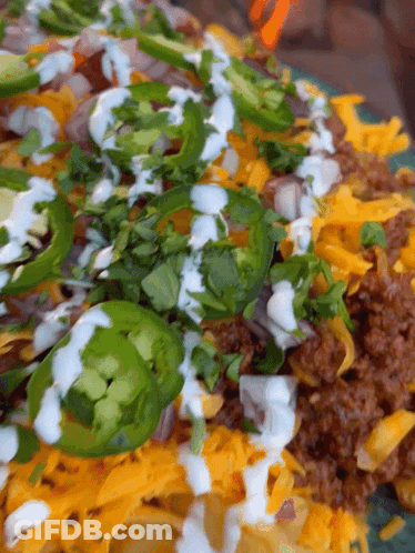 Plate Of Food With Jalapenos And Sour Cream GIF
