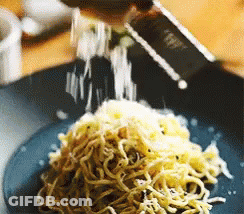 Plate Of Noodles With Cheese Being Grated GIF