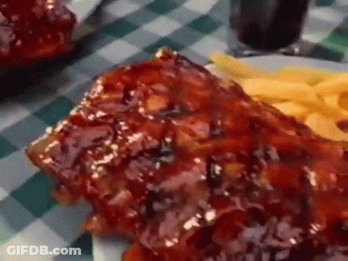 Plate Of Ribs And French Fries On Checkered Tablecloth GIF