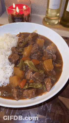 Plate Of Stew With Rice And Candle GIF