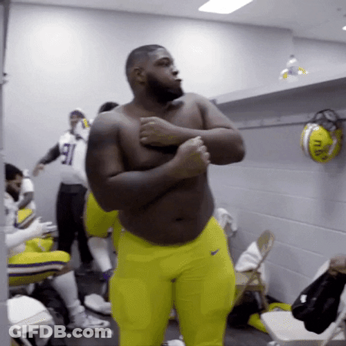 Player Under Ed Orgeron Biting Burger GIF