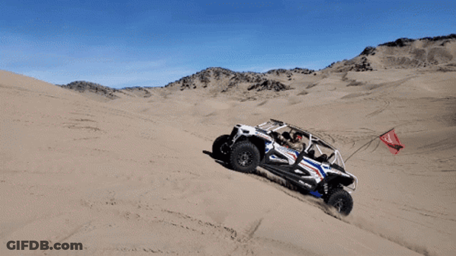 Polaris Curtis Buggy Catching Air Over Sand Dune GIF