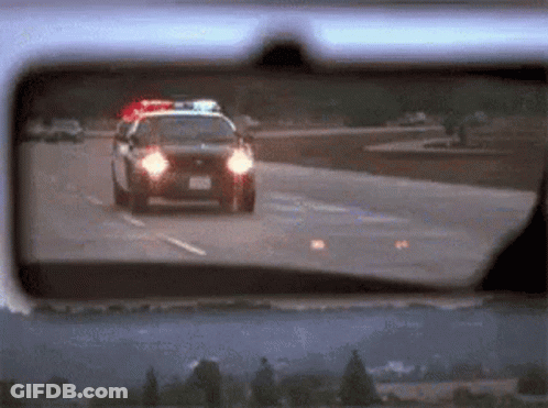 Police Car Driving Down Highway GIF