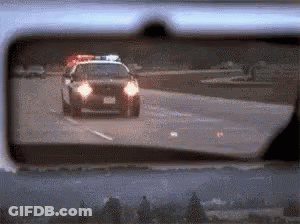 Police Car Driving Down Highway GIF