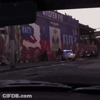 Police Car Parked In Front Of Ten Fye Building GIF