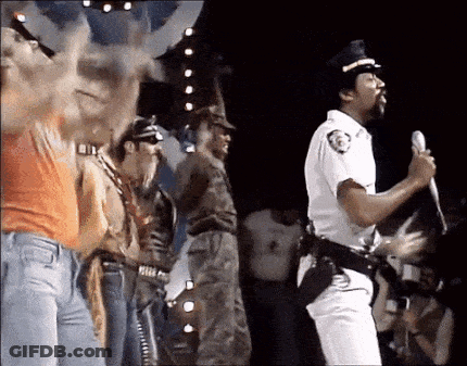 Police Man Singing Into Microphone On Stage GIF
