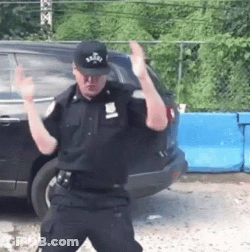 Police Officer Dancing In Front Of Car GIF