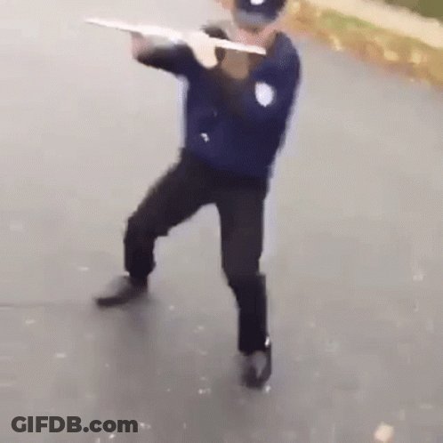 Police Officer Holding Gun On Street GIF