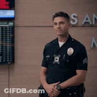 Police Officer In Front Of Los Angeles Sign GIF