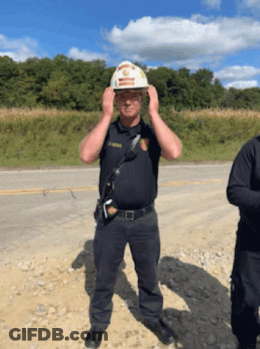 Police Officer In Hard Hat Adjusting Helmet GIF