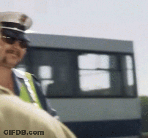 Police Officer In Sunglasses And Hat In Front Of Bus GIF