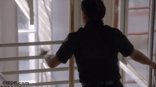 Police Officer Looking Out Window With CBS Logo GIF