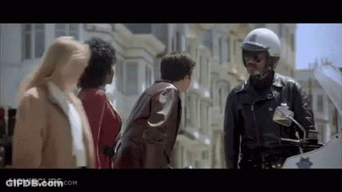 Police Officer On Motorcycle Talking To Group GIF