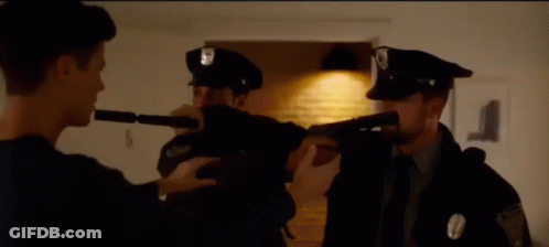 Police Officer Pointing Gun At Officer With Flashlight GIF