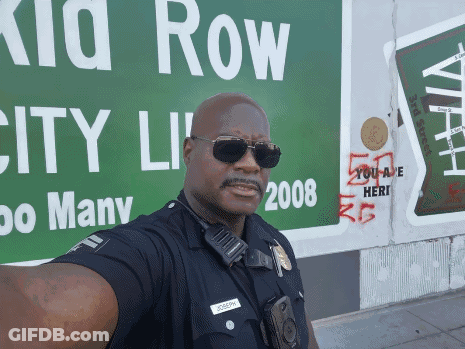 Police Officer Selfie With Green Kid Row Sign GIF